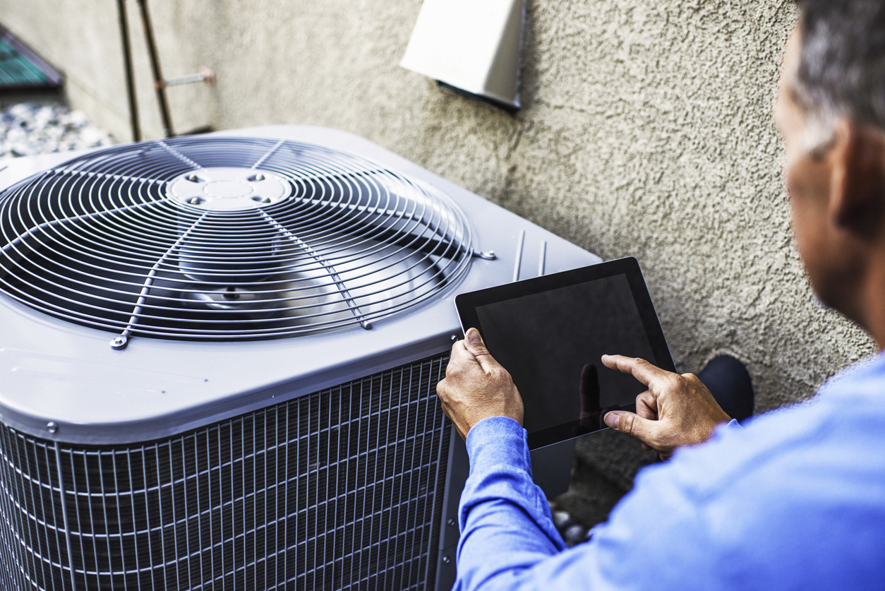 Technician Inspecting AC Unit