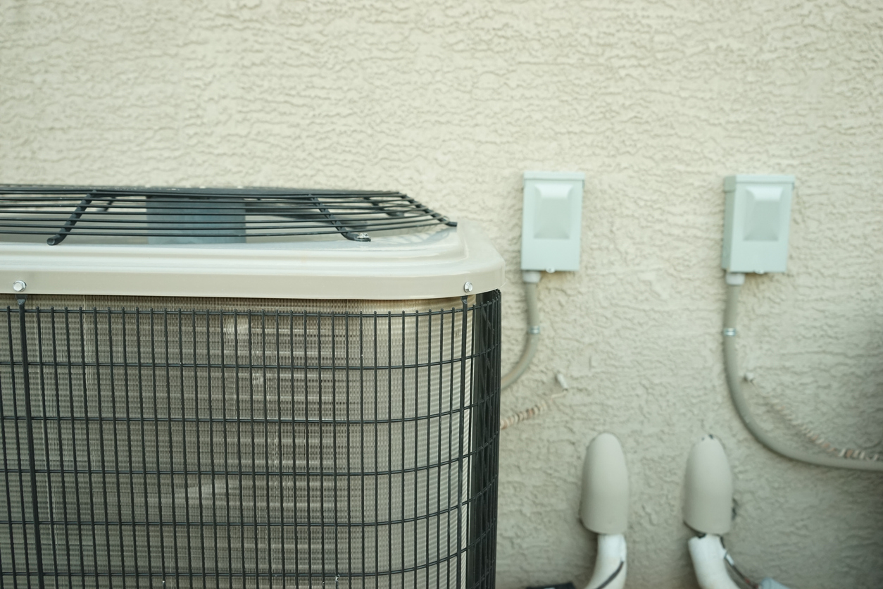 AC Unit and Stucco House